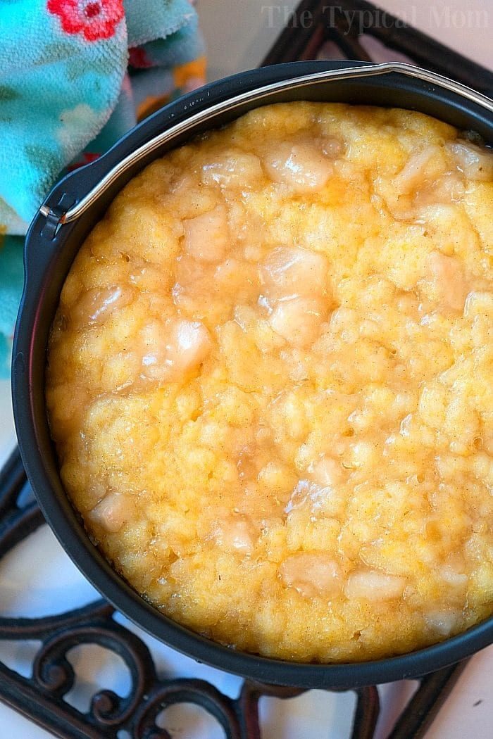 Warm, creamy instant pot dump cake, placed on a decorative trivet.