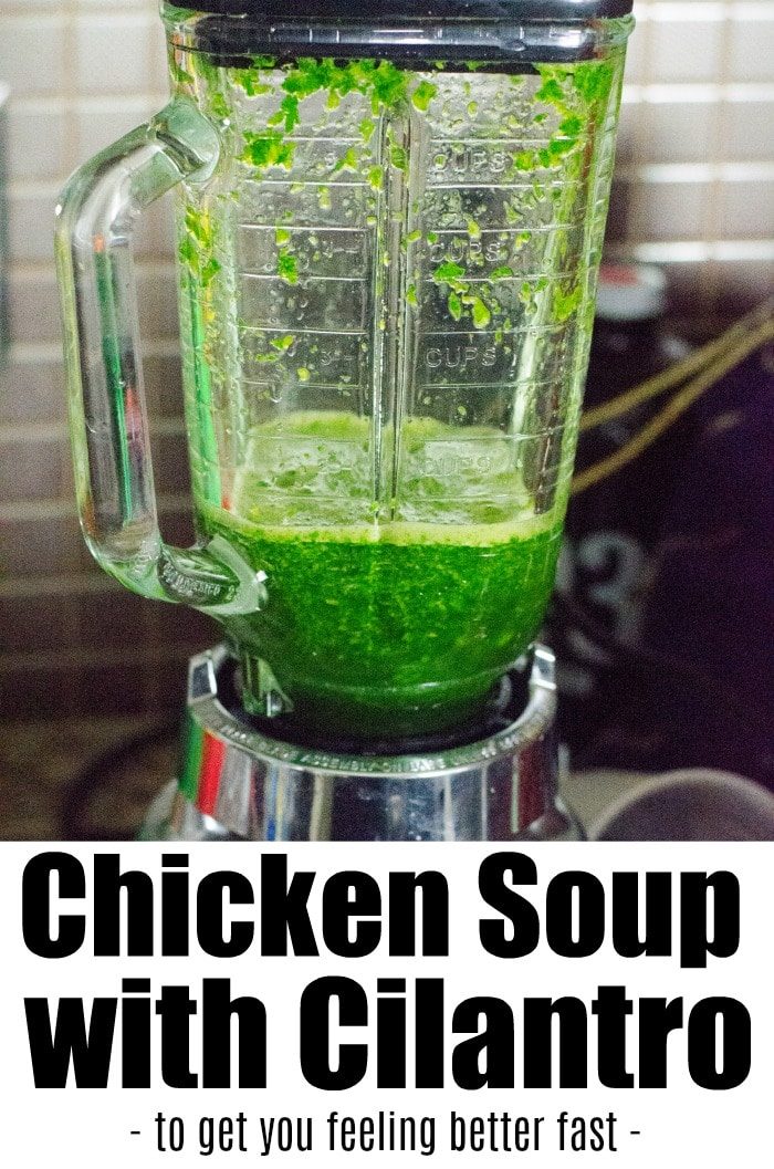 A blender filled with green cilantro mixture sits on a kitchen counter next to an Instant Pot. Text at the bottom reads: Feel Better Chicken Soup with Cilantro - to get you back on your feet fast.