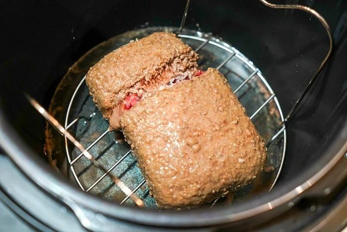 Thawed ground beef rests elegantly on a rack inside an Instant Pot, promising a flavorful delight.