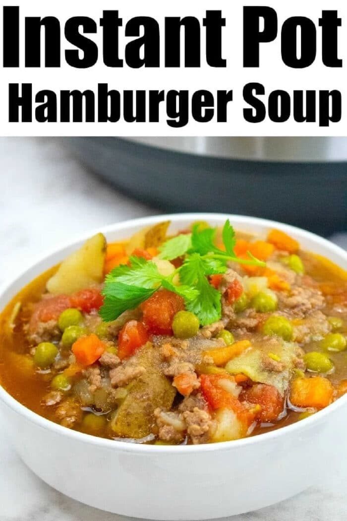 Bowl of hearty Instant Pot Hamburger Soup with potatoes, peas, carrots, tomatoes, and parsley, labeled Instant Pot Hamburger Soup with Potatoes.