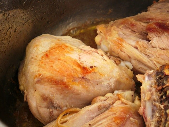 Cooked pieces of thighs in instant pot, infused with the zesty aroma of lemon garlic chicken, creating a delightful combination.