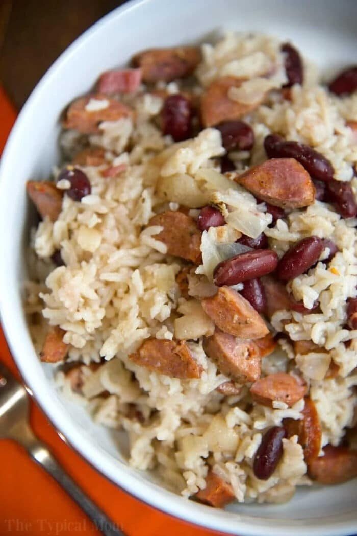 A bowl of rice mixed with kidney beans, chopped sausage, and onions—like a classic instant pot red beans and rice recipe.