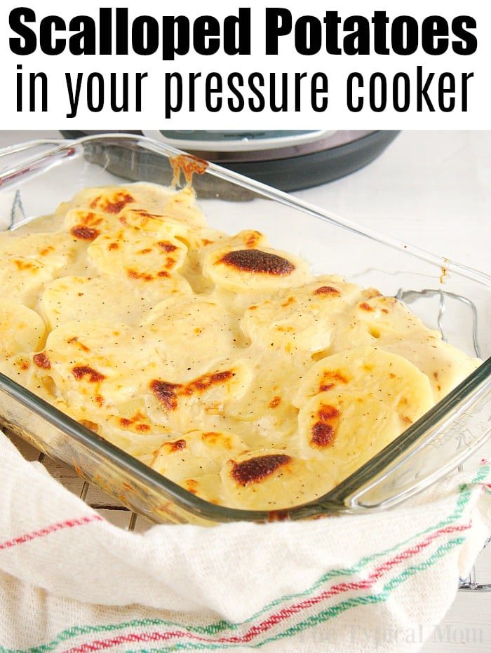 An inviting glass dish of golden-brown instant pot scalloped potatoes rests on a striped towel, showcasing layers of tender, creamy perfection.