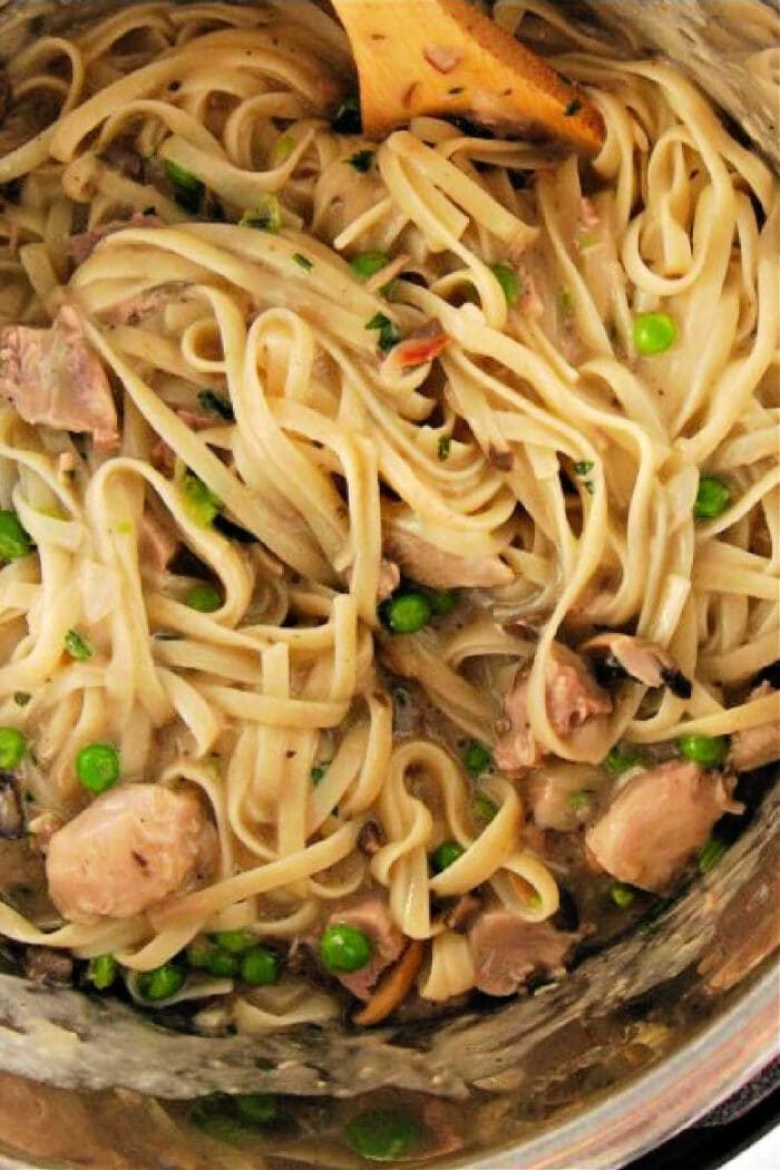 Savor the delightful twist on classic comfort food: Pasta with chicken, mushrooms, and peas gently stirred in a creamy sauce, reminiscent of an instant pot turkey tetrazzini.