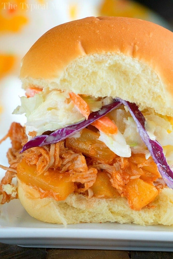 A delightful pulled pork sandwich with coleslaw and pineapple, solid for your July gatherings, crafted effortlessly with Instant Pot magic.