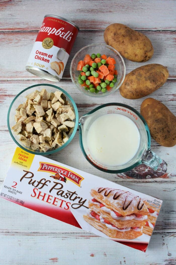 Ingredients for a good Chicken Pot Pie Recipe: potatoes, mixed veggies, milk, cream of chicken soup, cooked chicken, and puff pastry sheets—like the classic KFC Chicken Pot Pie!.