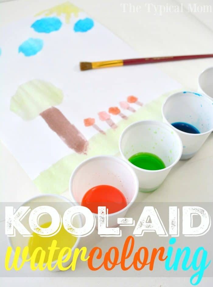 Watercolor painting with trees and sky using vibrant Kool-Aid paint; five cups filled with different colors and a brush are visible.