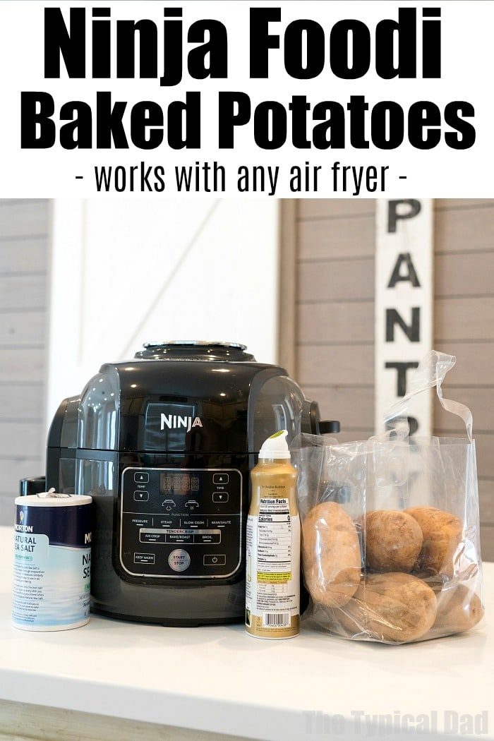 Ninja Foodi baked potatoes in a bag sit on the counter with salt and oil beside a Ninja air fryer. "Ninja Foodi Baked Potatoes" is written above, highlighting this simple and good method.