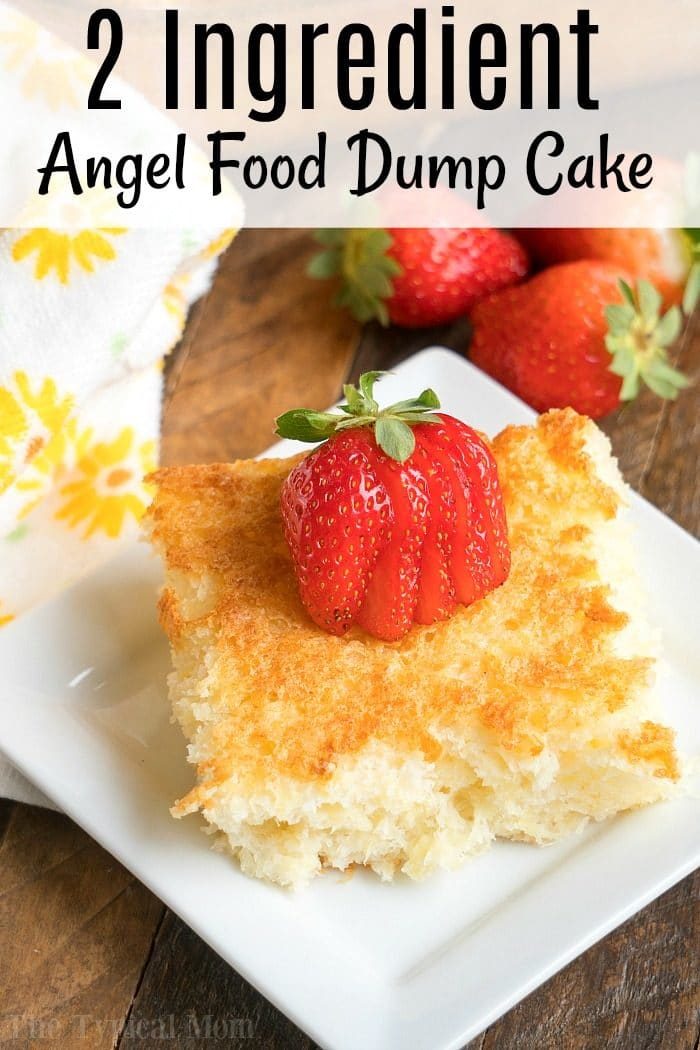 A slice of pineapple angel food dump cake topped with sliced strawberries rests on a white plate, accompanied by a yellow flower-patterned cloth.