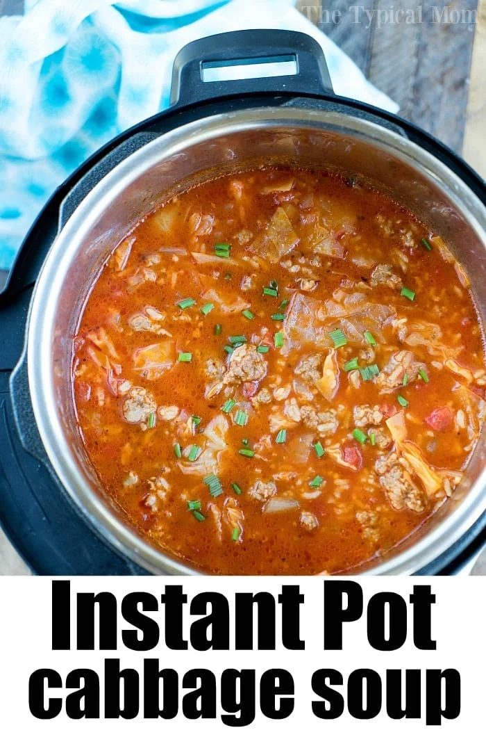 Overhead view of pressure cooker cabbage soup with ground meat in an Instant Pot, garnished with chopped chives.