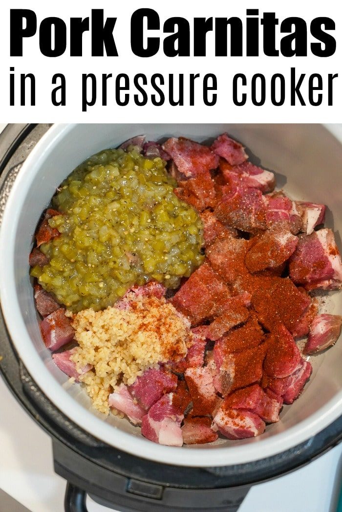 An overhead view reveals a pressure cooker brimming with raw pork chunks, vibrant green chilies, minced garlic, and bold red spices, all set for crafting good pressure cooker carnitas. The text above declares, "Pork Carnitas in a Pressure Cooker.