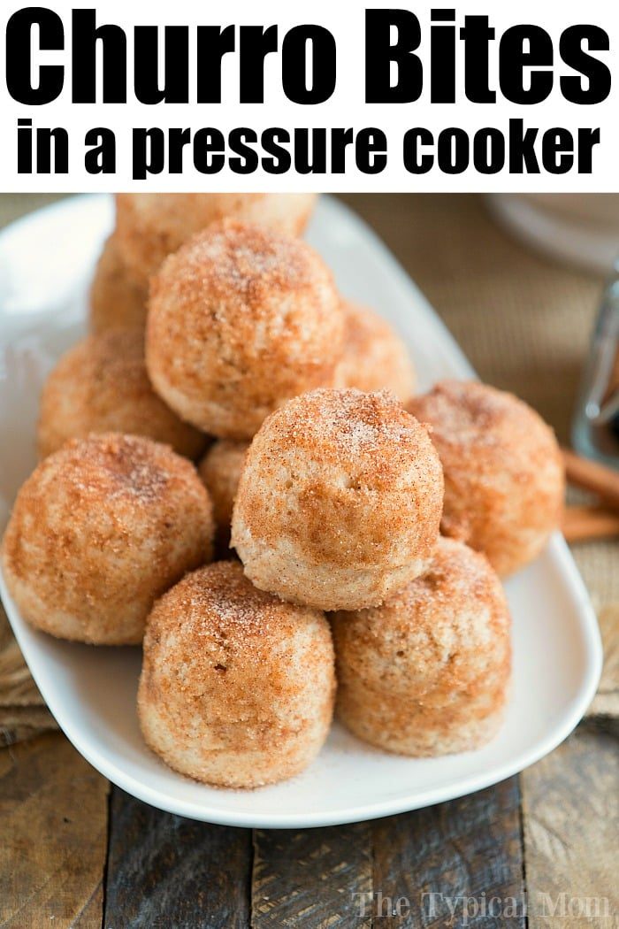 A plate of pressure cooker churro bites is stacked in a pyramid shape. These delightful treats are perfectly coated with cinnamon sugar, offering a crispy texture and heavenly aroma.