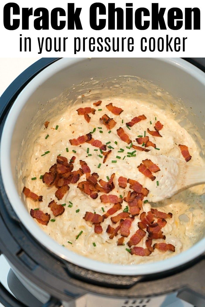 Close-up of a Ninja Foodi pressure cooker filled with creamy chicken topped with crispy bacon bits and chopped chives. The text reads Crack Chicken made easy. A wooden spoon rests in the mixture, ready to serve a good meal.