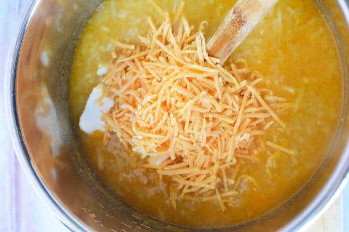 Shredded cheese melts into a creamy yellow soup, bubbling gently in the pot as a wooden spoon stirs. This Pressure Cooker Potato Soup is made even heartier with the addition of Frozen Hash Browns for a comfort meal thats both quick and good.