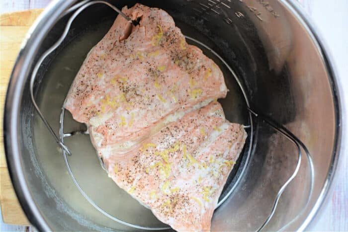 Salmon fillets infused with pepper and lemon zest, cooked effortlessly in a pressure cooker.
