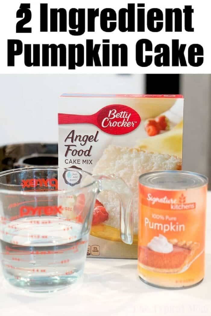 Box of angel food cake mix, a can of pumpkin, and a measuring cup of water sit on the counter—ingredients ready to make a good pumpkin angel food cake.
