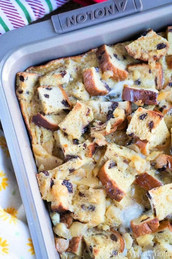 A baking pan filled with chunky bread pudding made from chocolate chip and raisin bread pudding.