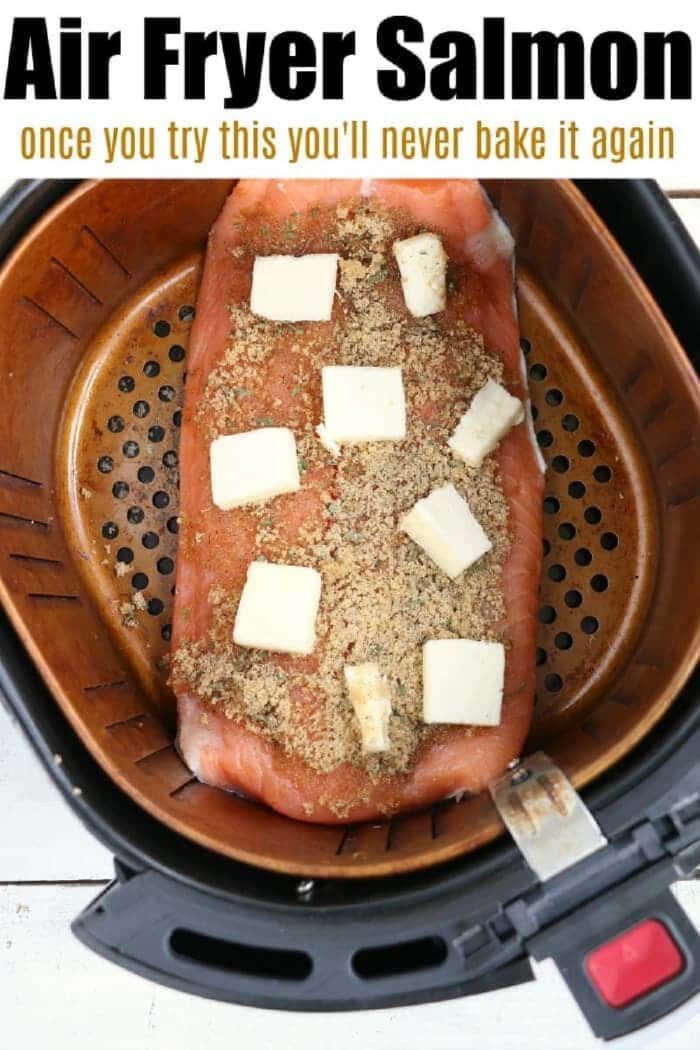 Salmon filet with seasoning and butter cubes in an air fryer basket, ready to be cooked—solid for making good salmon in the air fryer.