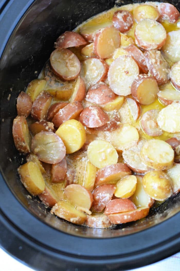 Sliced red potatoes cooked in a creamy sauce inside a slow cooker, this dish is one of the best easy potato recipes and solid for anyone who loves crockpot potatoes.