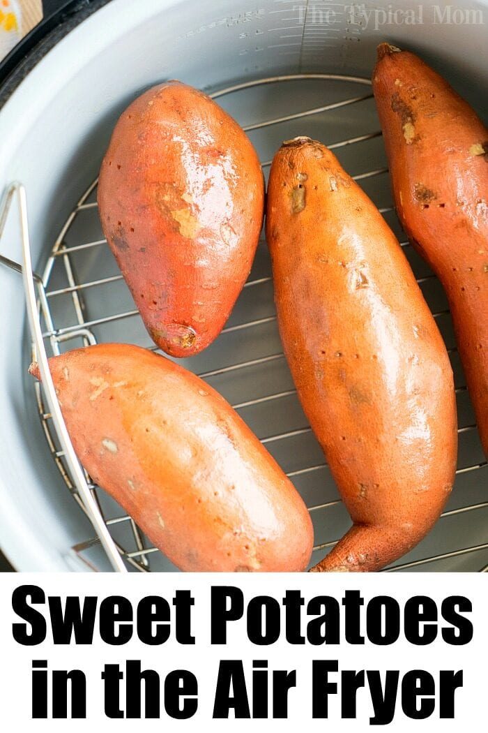 Four sweet potatoes rest on a rack inside the ninja foodi, perfectly positioned for an even cook.