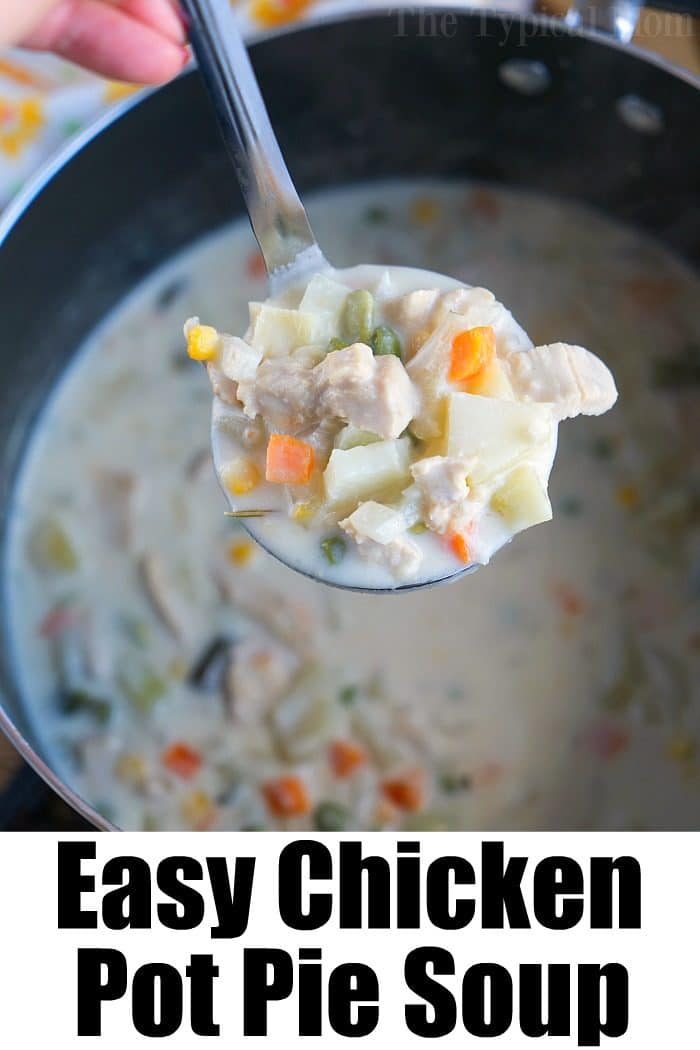 A ladle filled with creamy turkey pot pie soup hovers over a pot
