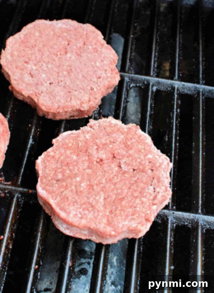 Grill Frozen Burgers to Perfection 4 Frozen burger patties being prepared for the grill