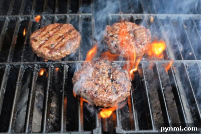 Grill Frozen Burgers to Perfection 6 Grilled hamburgers cooking on the BBQ, ready for a summer meal