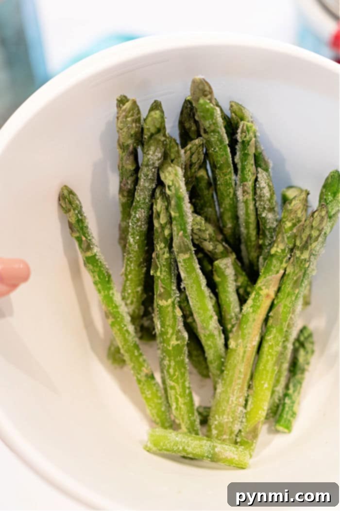 Crispy Air Fryer Frozen Asparagus 5 How to cook frozen asparagus: perfectly seasoned and cooked spears in an air fryer basket.