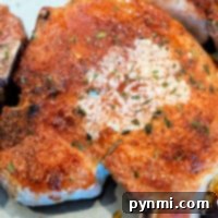 Learn how to cook 2-inch thick pork chops seasoned and baked on a baking sheet for a deliciously juicy experience.
