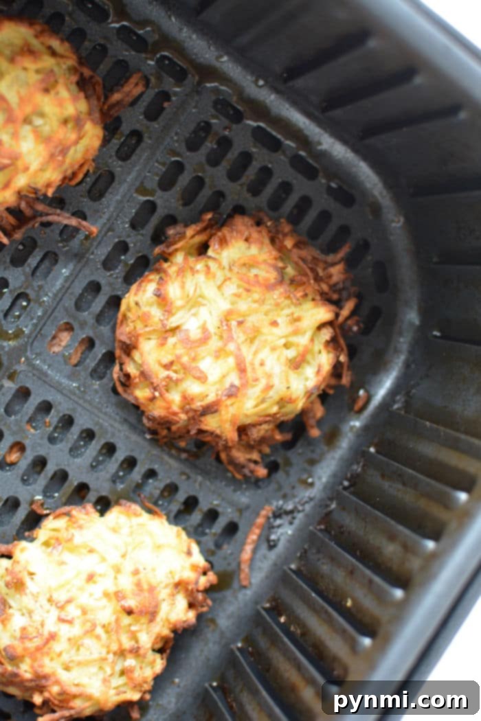 A batch of freshly cooked Ninja Foodi latkes, perfectly golden and crispy.