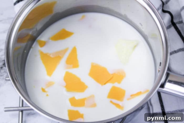 A close-up of the rich, golden Chick Fil A Mac and Cheese sauce, showing its creamy texture before being mixed with pasta.