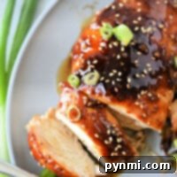 Delicious Teriyaki Chicken Made Simple with Bottled Sauce 8 Sliced teriyaki chicken breast on a plate, topped with sesame seeds and green onions