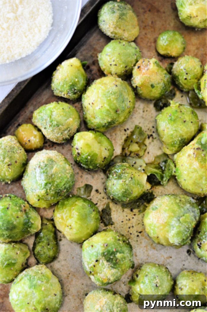 Discover how to cook frozen Brussels sprouts by roasting them to perfection, seasoned with a medley of spices on a baking tray.
