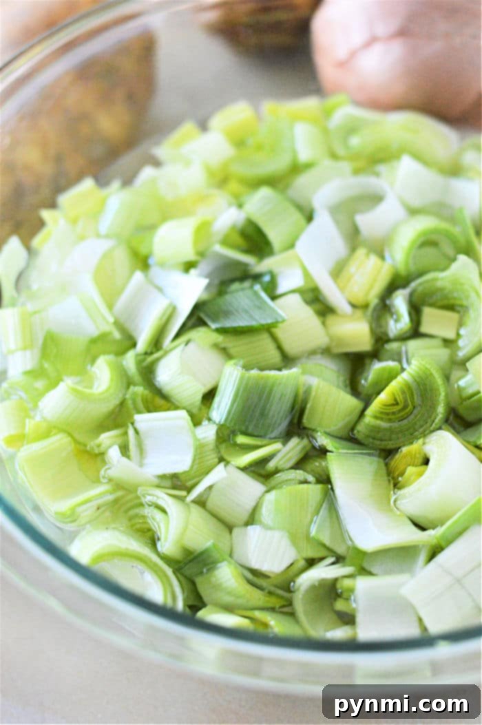 Velvety Instant Pot Potato Leek Comfort 4 Fresh leeks on a cutting board, ready for cleaning and preparation.