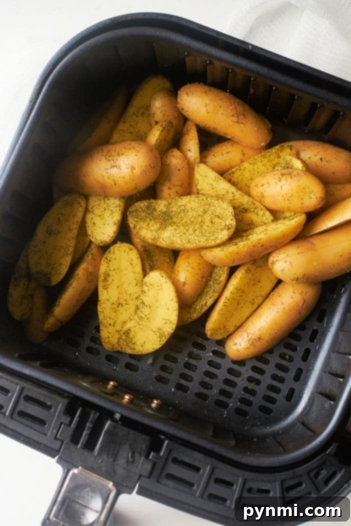 Crispy Air Fryer Fingerling Potatoes 6 Herb-roasted fingerling potatoes in a serving bowl, garnished