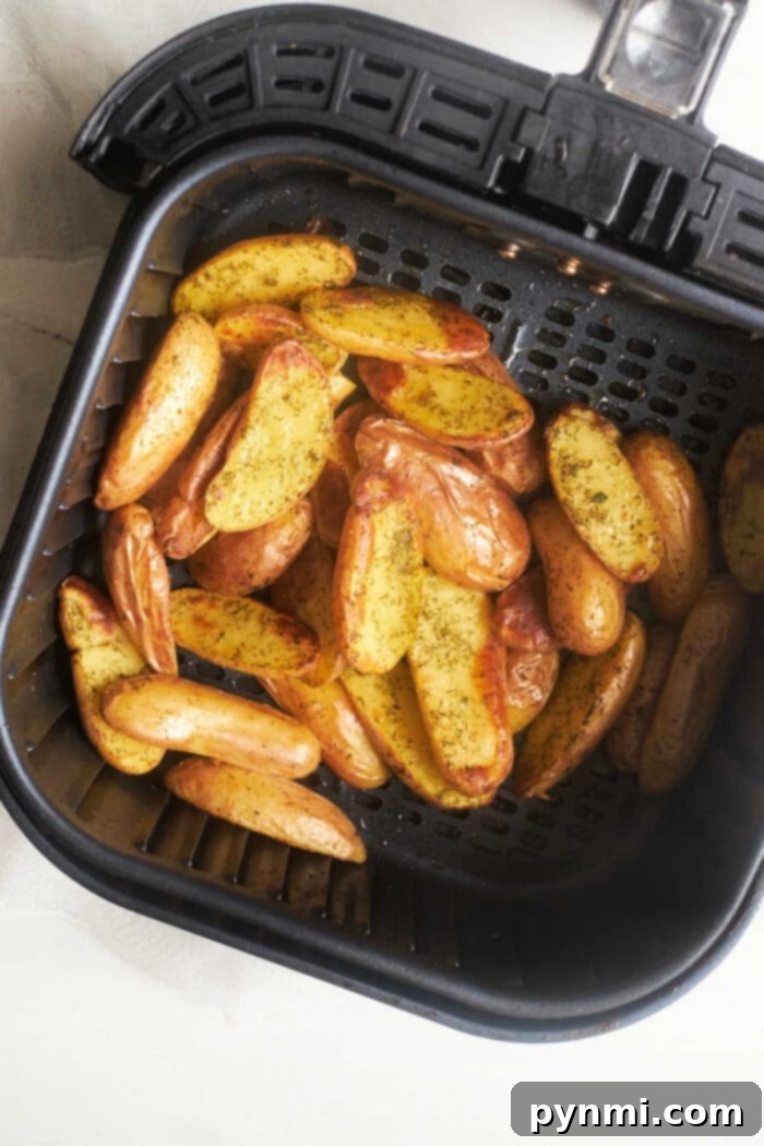 Crispy Air Fryer Fingerling Potatoes 7 Platter of perfectly roasted fingerling potatoes garnished with fresh herbs