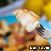 Cooking Frozen Scallops to Perfection 7 Grilled scallop on a fork with a dish of scallops in the background showcases the perfect result when you know how to cook frozen scallops to perfection.