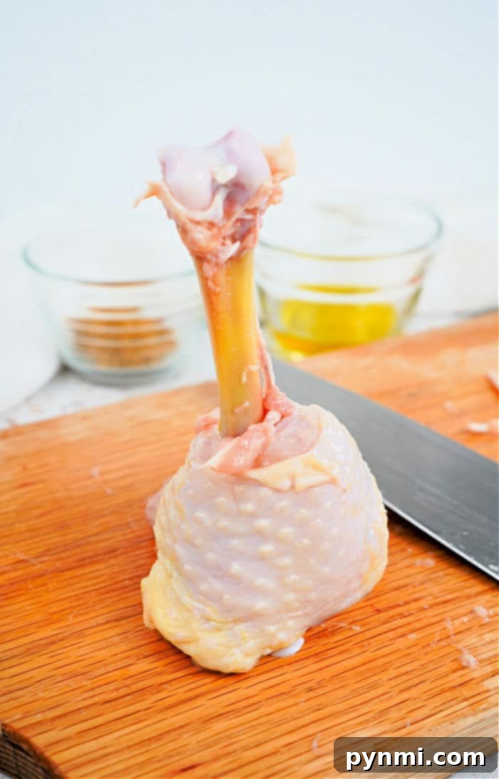 Perfect Lollipop Chicken Drumsticks 3 Close-up of three seasoned lollipop chickens, highlighting the rich color and succulent skin.