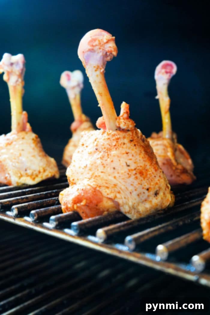 Smoky Chicken Lollipops 4 Preparing Smoked Chicken Lollipop, showing the raw drumstick with meat pushed down the bone.