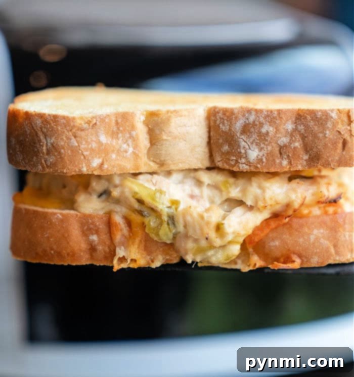 Crispy Air-Fried Tuna Sandwich 12 A step-by-step visual guide demonstrating how to expertly assemble a tuna melt, from layering the tuna mixture to placing the top slice of bread for ideal air frying results.