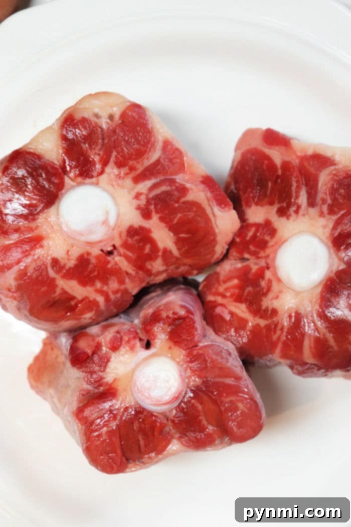 Tender Oven-Braised Oxtails 4 raw oxtail cuts seasoned and ready for cooking