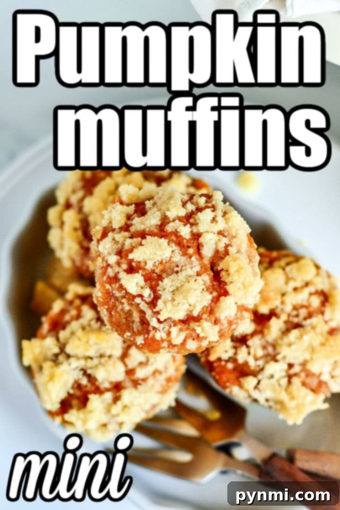 A cluster of freshly baked mini pumpkin muffins arranged on a rustic wooden board.