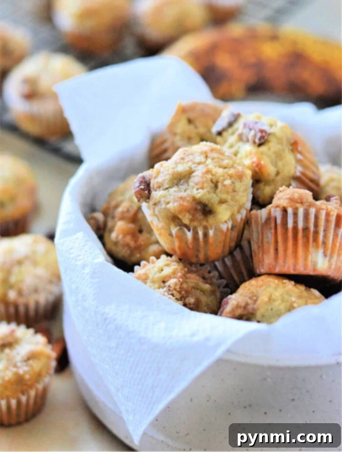 Perfectly baked golden-brown mini muffins in a muffin tin, ready to be enjoyed.