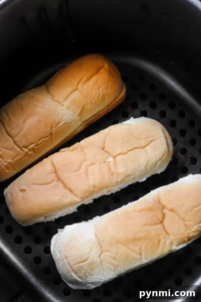 Air Fryer Frozen Hot Dogs served with toasted buns.