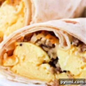Crispy Ninja Foodi Air Fryer Breakfast Burritos 9 Close-up of breakfast burritos, perfectly cooked in an air fryer, filled with scrambled eggs and sausage.