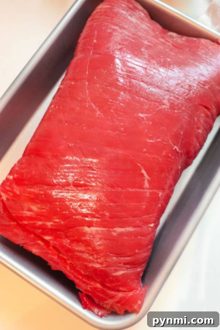 Perfectly Tender Air Fryer Brisket 4 Uncooked beef brisket with a prominent fat cap, expertly trimmed and ready for the application of a delicious dry rub.