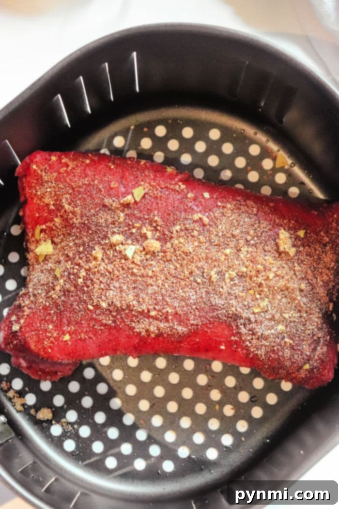 Perfectly Tender Air Fryer Brisket 5 Air Fryer Beef Brisket with a beautiful, rich crust after the initial searing stage in the air fryer, showcasing the perfect caramelization.