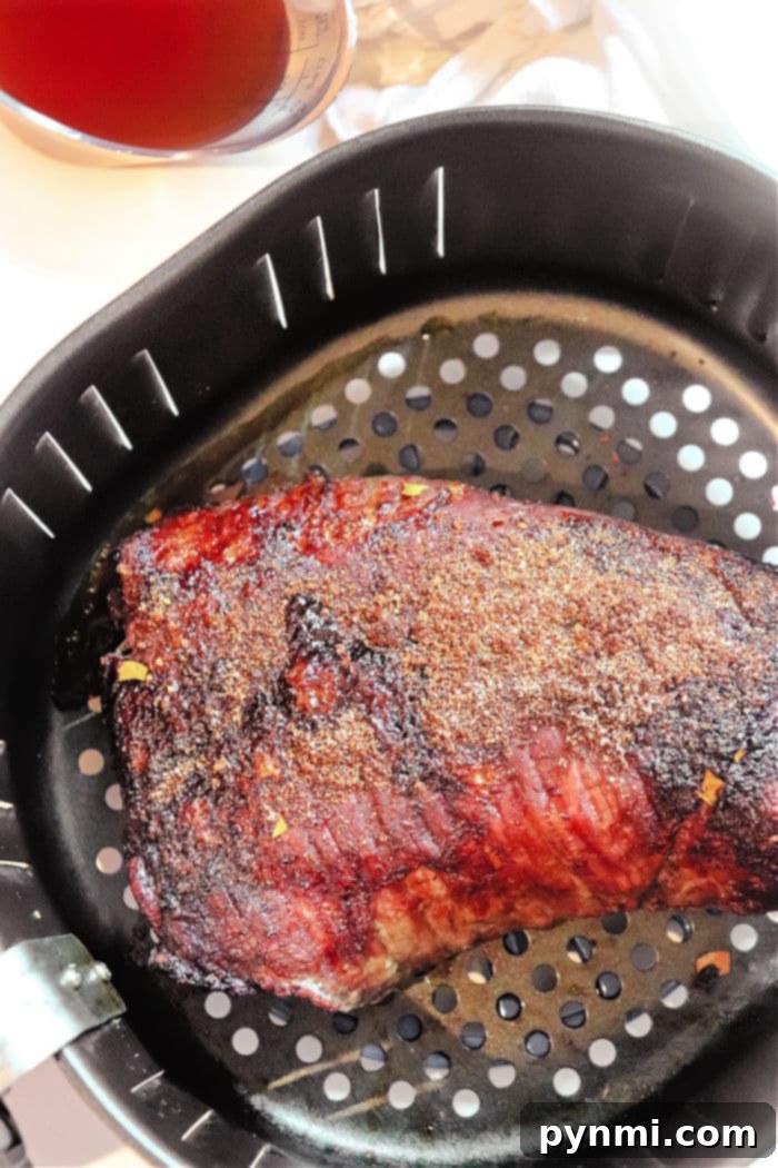 Perfectly Tender Air Fryer Brisket 6 Ninja Air Fryer cooking brisket, demonstrating how various air fryer models can achieve excellent results for this recipe.