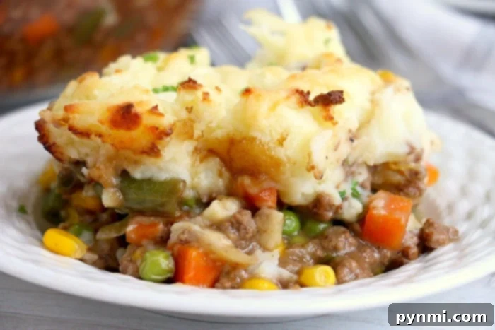 Slow Cooker Comfort Shepherd's Pie 8 Easy Shepherd's Pie made with frozen vegetables, served in a dish.