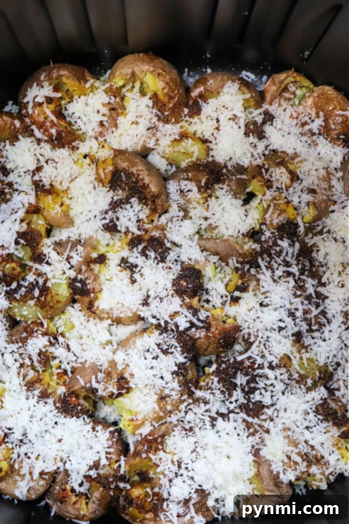Golden Crispy Air Fryer Smashed Potatoes 6 Smashed potatoes in Ninja Foodi, topped with melted cheese and crispy breadcrumbs.